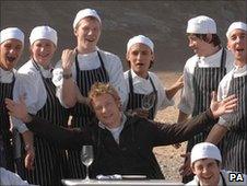 Chef Jamie Oliver with staff at his Fifteen restaurant in Cornwall