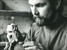 John Hughes carving a statue