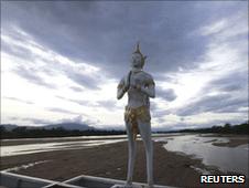 Statue on the drying Ping river in Thailand