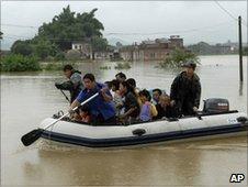 Residents are evacuated after heavy rains caused floods in Huaiji in Guangdong province, China, on 15 June, 2010
