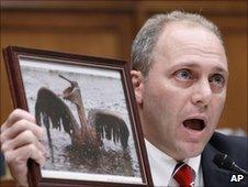 Representative Steve Scalise holds photo of an oiled bird