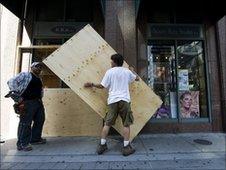 Workers install plywood sheets on street level condos in Toronto, Canada, on 23 June, 2010