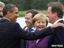 Barack Obama jokes with David Cameron (R), Dmitry Medvedev and Angela Merkel watch