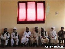 Village elders sit before the start of a shura meeting with local Afghan government officials and officers from the US