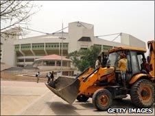Clearing debris outside The Indira Gandhi Indoor Stadium Complex