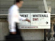 A commuter walks past the Whitehall road sign