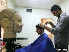 A barber cuts hair at an official hairstyle show in Tehran