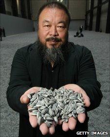 Chinese Artist Ai Weiwei holds some seeds from his installation Sunflower Seeds
