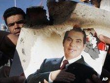 Protesters in Tunis burn a photo of former President Zine al-Abidine Ben Ali. in January 2011
