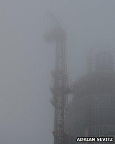 Crane surrounded by fog