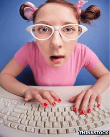 Girl wioth glasses using a keyboard