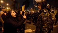 A woman attending a vigil in Tehran for those killed in the Ukraine International Airlines plane crash confronts a policeman (11 January 2020)