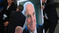 Officials install a portrait of Mr Kohl at the European Parliament