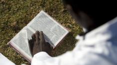 A worshipper reads the bible