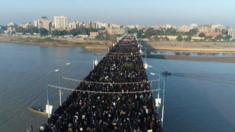 Mourners walk over a bridge in Ahvaz