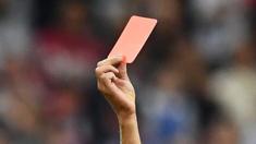 A referee showing a red card
