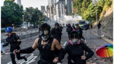 Protesters run on a street during an attempt to leave Polytechnic University