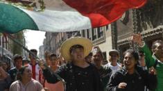 A South Korean man waves the Mexican flag in Zocalo square, Mexico City