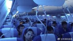 Aircraft passengers with oxygen masks dropped