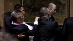 Police officers carry away opposition deputy Slaven Radunovic from the Democratic Front