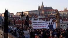 Demonstrators march across the medieval Charles Bridge during a protest rally demanding resignation of Czech Prime Minister Andrej Babis on 17 November, 2018