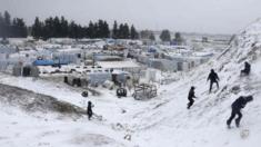 Syrian refugees play with snow during a winter storm in Zahle town, in the Bekaa Valley on 11 December 2013.