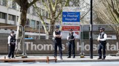 Police officers stand in front of barriers erected outside St Thomas" Hospital in London where Boris Johnson is in intensive care