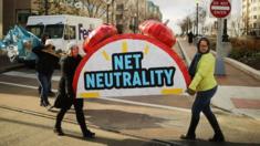 women carrying a net neutrality sign