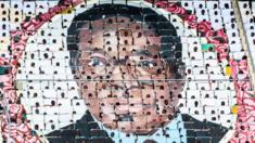 Schoolchildren hold up images to create a mosaic of Robert Mugabe's face at a stadium in 2017.