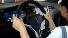 driver at wheel of Tesla