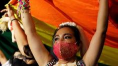 LGBT activists raise a rainbow flag during a protest in Bangkok, Thailand. Photo: 25 July 2020