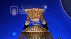 Lottery balls are dropped into a rotating drum during Spain"s Christmas lottery "El Gordo"