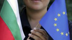 File image of woman holding a Bulgarian flag and an EU flag