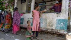 Homeless people receive free food offered by the Telangana state governement during a 21-day government-imposed nationwide lockdown as a preventive measure against the COVID-19 coronavirus in Hyderabad