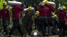 Thai rescue teams carry oxygen cylinders