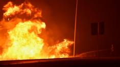 A firefighter battles a massive blaze