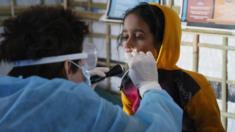 British nurse Becky Platt examines a young girl with suspected dyptheria