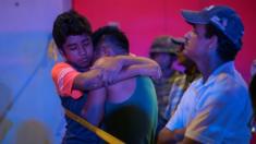A man is comforted at a crime scene following a deadly attack at a bar by unknown assailants in Coatzacoalcos, Mexico August 28, 2019.