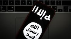 The logo of the so-called Islamic State is seen on a mobile phone