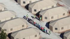Children walking between tents at the Tornillo camp in Texas