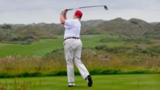 Donald Trump plays a stroke as he officially opens his new multi-million pound Trump International Golf Links course in Aberdeenshire, Scotland, on July 10, 2012.