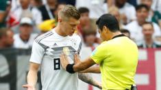 Toni Kroos pushed by the referee