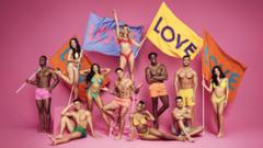The 2022 Love Island contestants holding flags that read Love. The new series started on ITV on 6 June