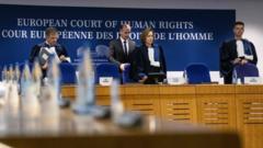 Irish chairman of ECHR, Siofra O'Leary (C) and Slovenia judge Marko Bosnjak (R) arrive for the European Court of Human Rights hearing in two climate change cases involving France and Switzerland, on March 29, 2023 in Strasbourg, eastern France.