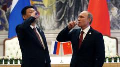President of Russia Vladimir Putin and Chinese President Xi Jinping toast with vodka during a signing ceremony on May 21, 2014 in Shanghai,