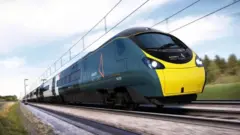 Avanti West Coast train speeding along the track. It is dark blue/green with a yellow front and a streamlined shape.