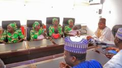Some of di women, dia pikin with Borno state goment officials