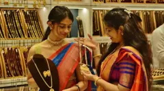 Getty Images Two women look at gold on display at a gold jewelery shop