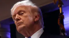 Donald Trump is talking to the press.