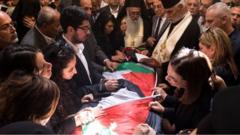 Mourners surround the coffin of killed journalist Shireen Abu Aqla